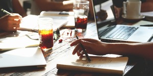 Close up of table with notebooks and a laptop